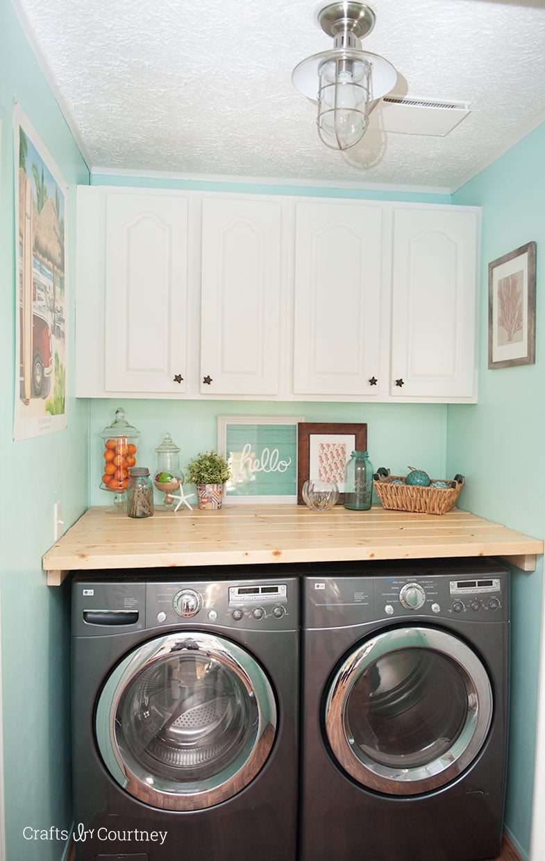 Give your cabinets a simple makeover with some satin enamel paint. Cabinet makeovers are so popular right now, no need to keep ugly colored cabinets.  I just love how my whole laundry room makeover turned out!