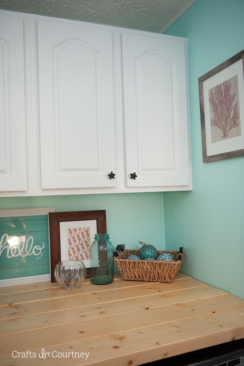 Give your cabinets a simple makeover with some satin enamel paint. Cabinet makeovers are so popular right now, no need to keep ugly colored cabinets.  I just love how my whole laundry room makeover turned out!